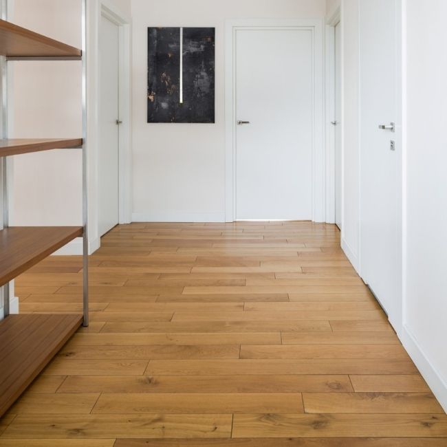 Image depicts a hallway in a home with newly installed French oak hardwood floors.
